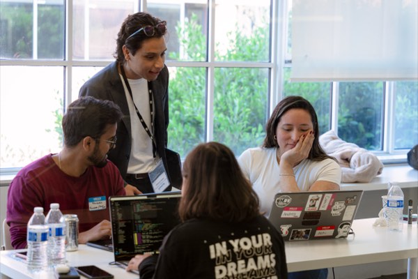Laughs mid-build at the AI for Good hackathon